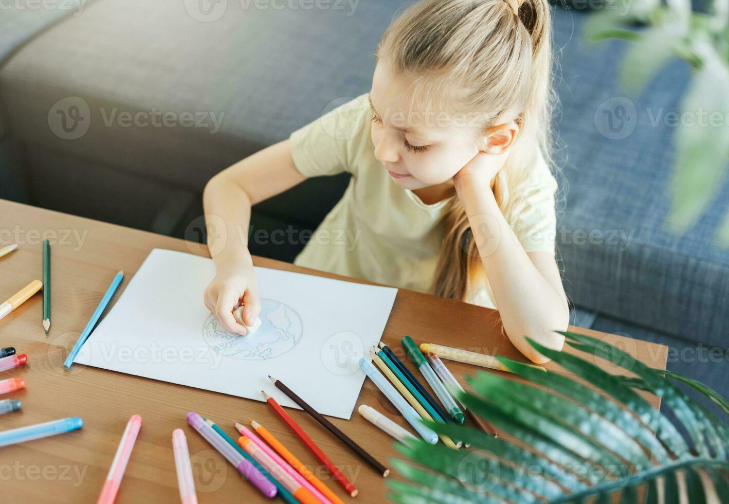 Child girl drawing with colorful pencils photo