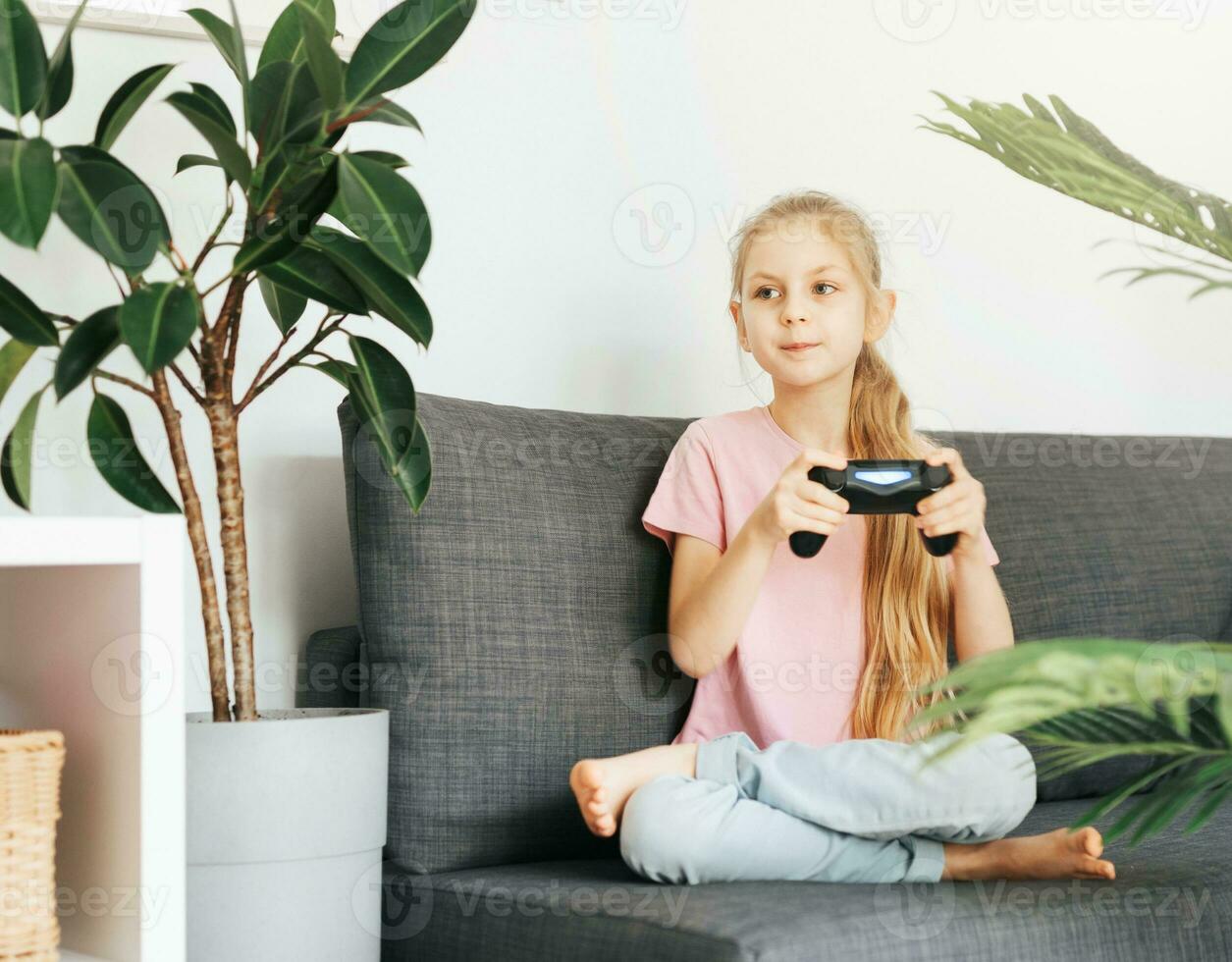 Girl playing video game at home photo