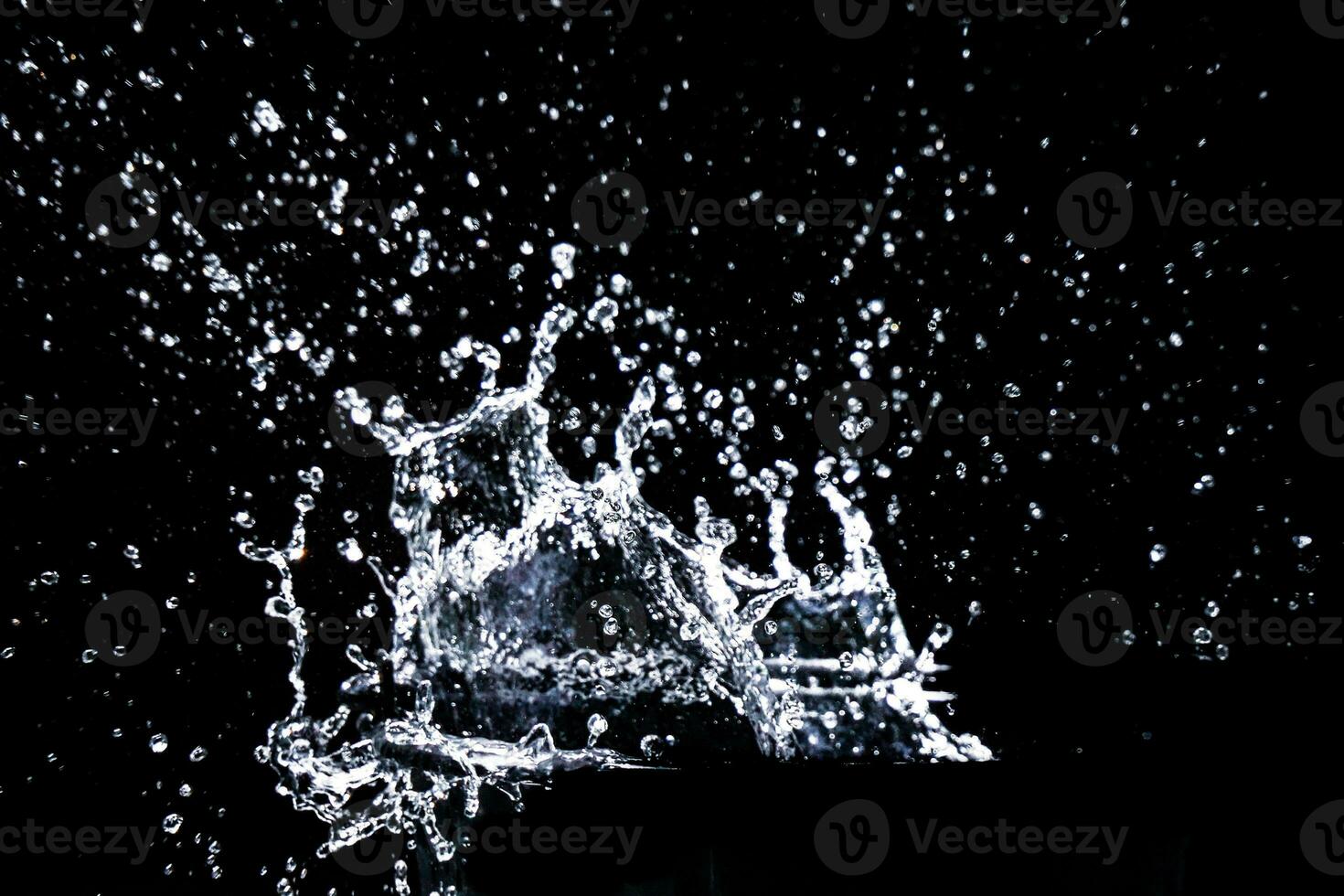 water splash in a glass. water splash isolated on black. photo