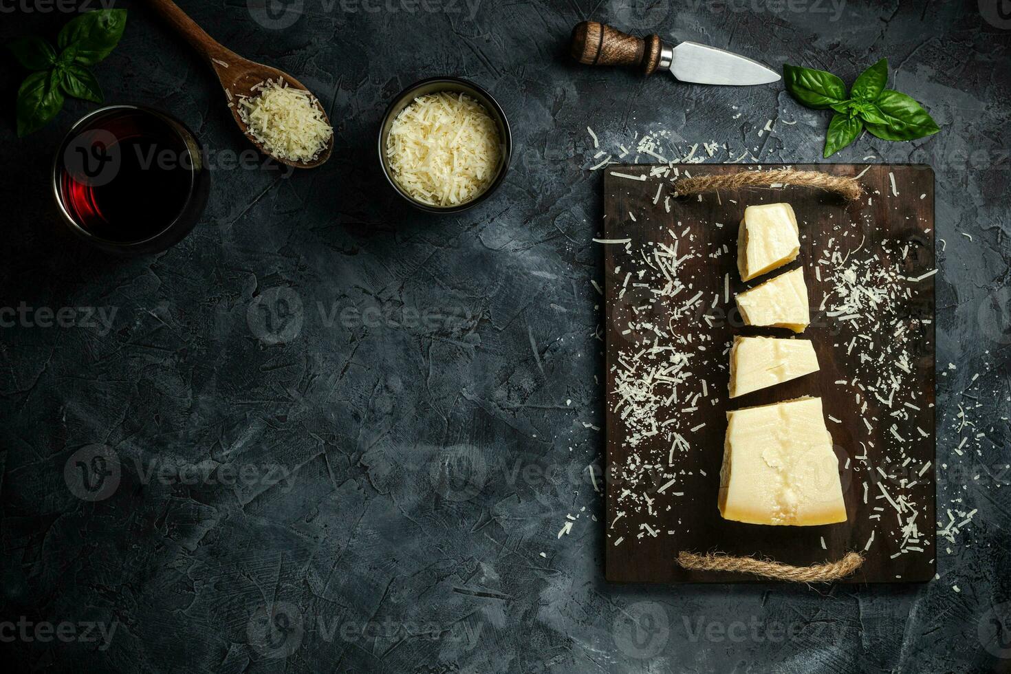 Top view of triangular piece of hard cheese on wooden cutting board photo