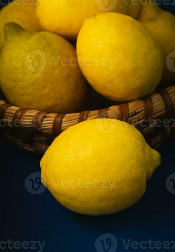 Basket with ripe lemons. On a rustic blue dark background. High quality photo