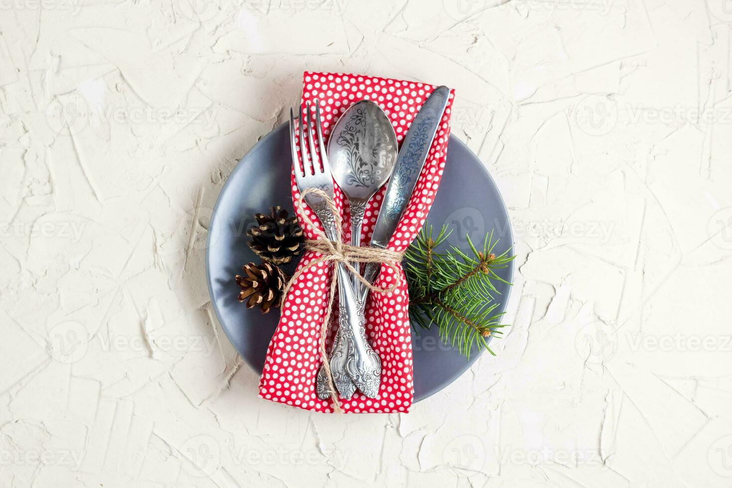 Christmas menu background with fork knife napkin and fir tree brunch on white table. Copy space, top view photo