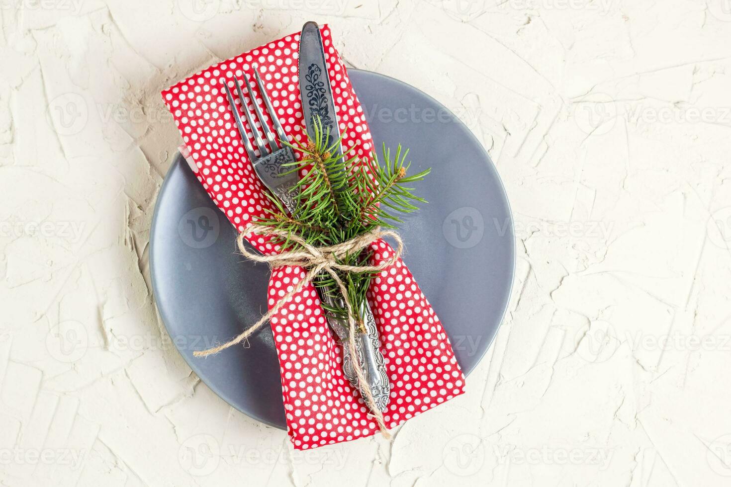Christmas menu background with fork knife napkin and fir tree brunch on white table. Copy space, top view photo