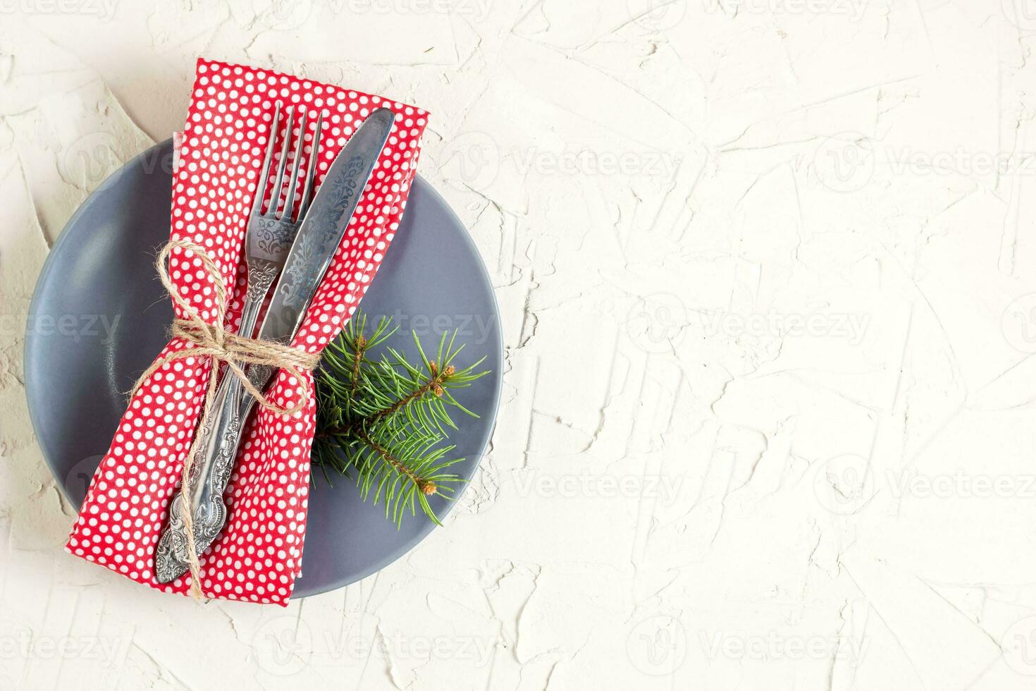 Christmas menu background with fork knife napkin and fir tree brunch on white table. Copy space, top view photo
