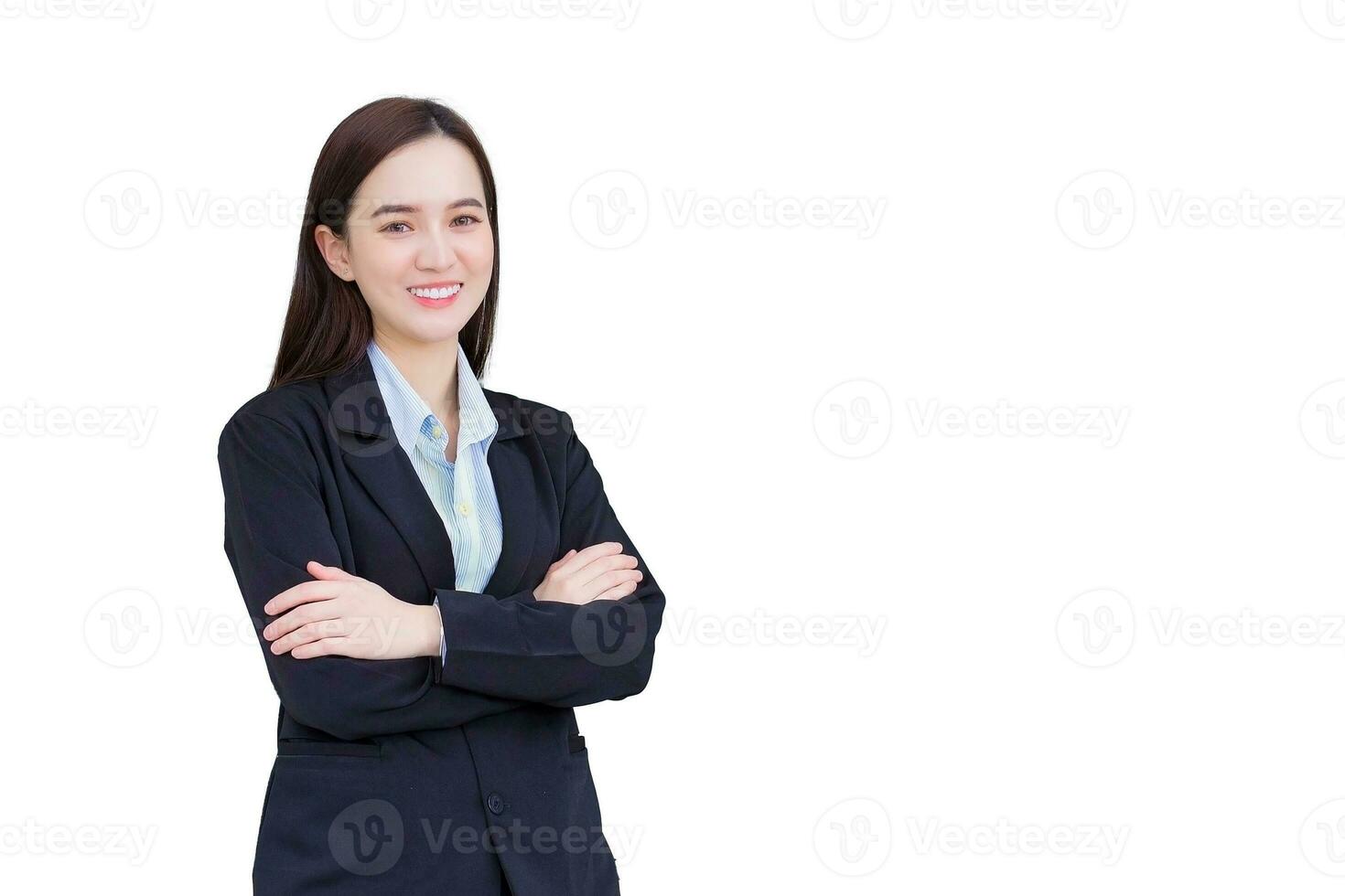 Professional young business Asian working woman who has long hair wears black formal suit with blue shirt while she arm crossing and smiling happily isolated on white background. photo