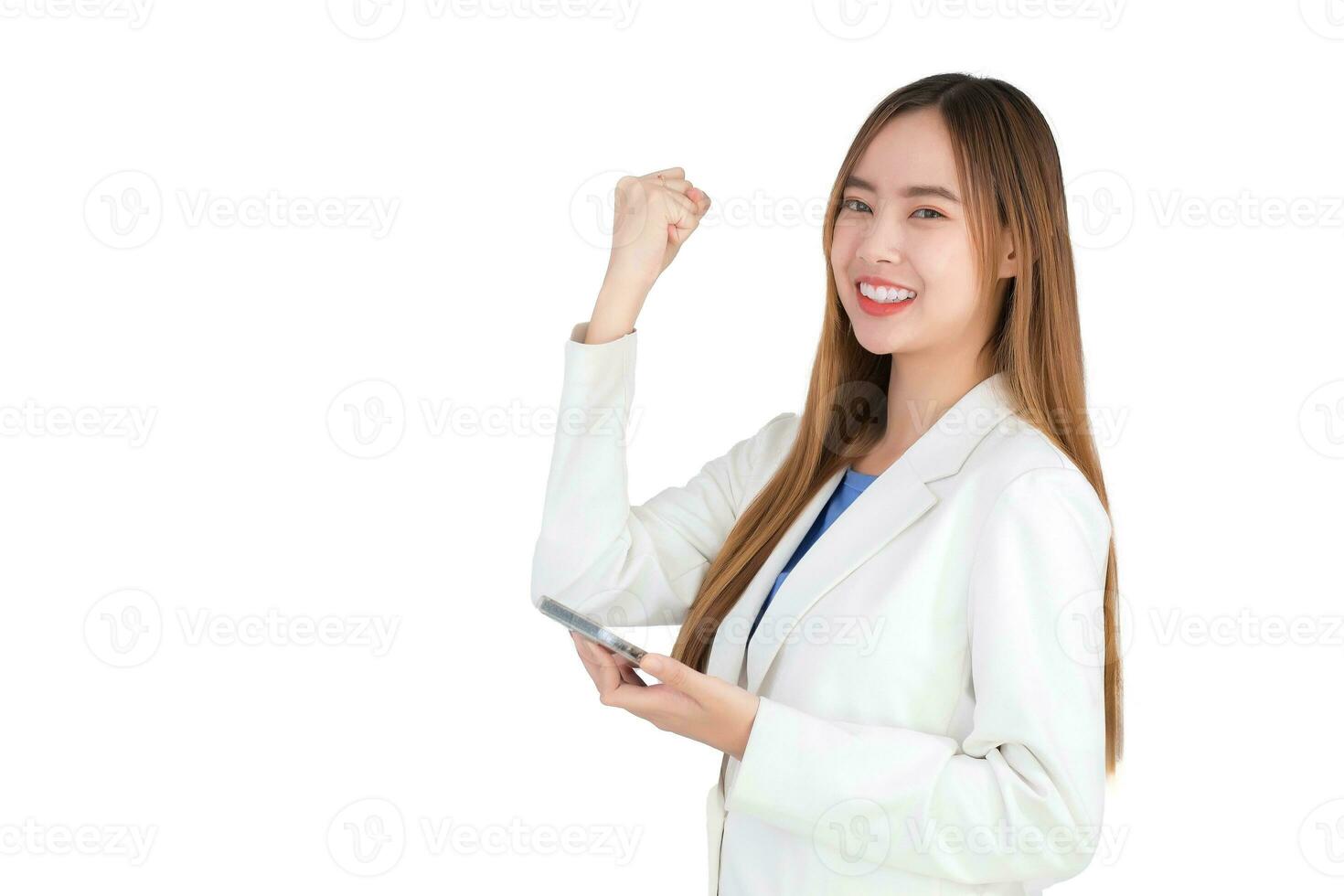 professional Asian business woman in a white suit smiles happily successful while holds smartphone isolated on white background. photo