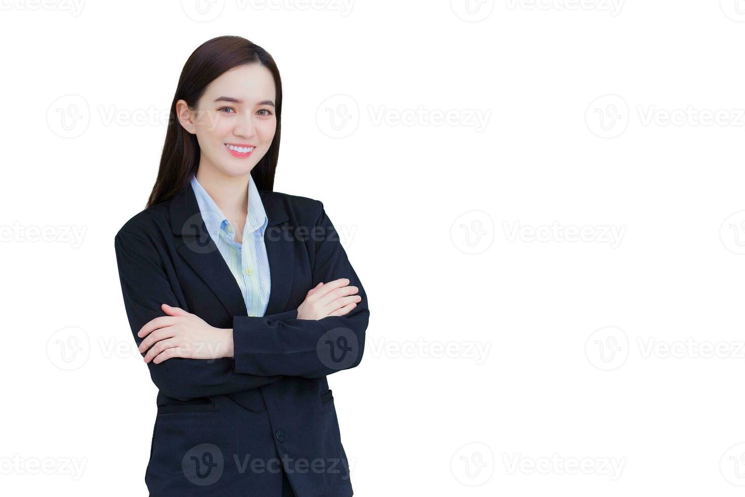 Professional confident Asian working woman who has long hair wears black formal suit with blue shirt while she arm crossing and smiling happily isolated on white background. photo