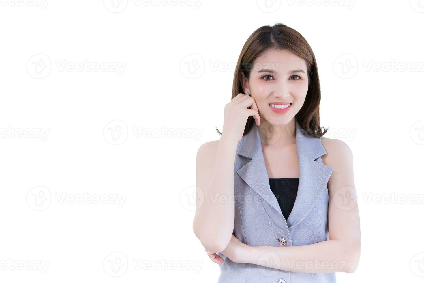 Asian professional working woman has black long hair in gray shirt. She is smiling and standing confident while isolated on white background. photo