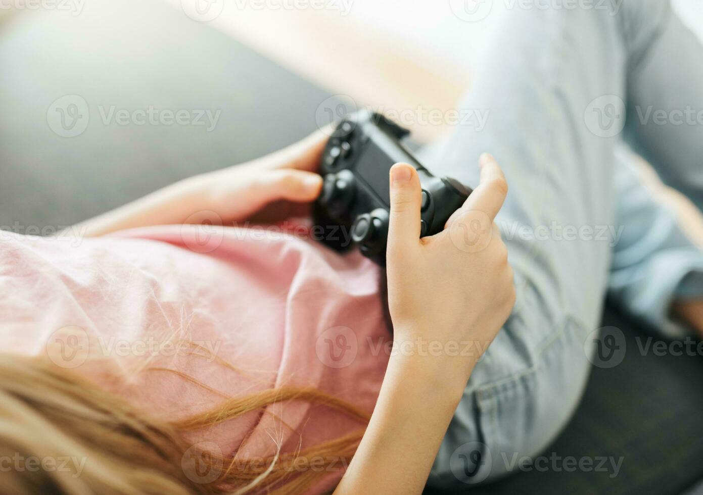 Girl playing video game at home photo