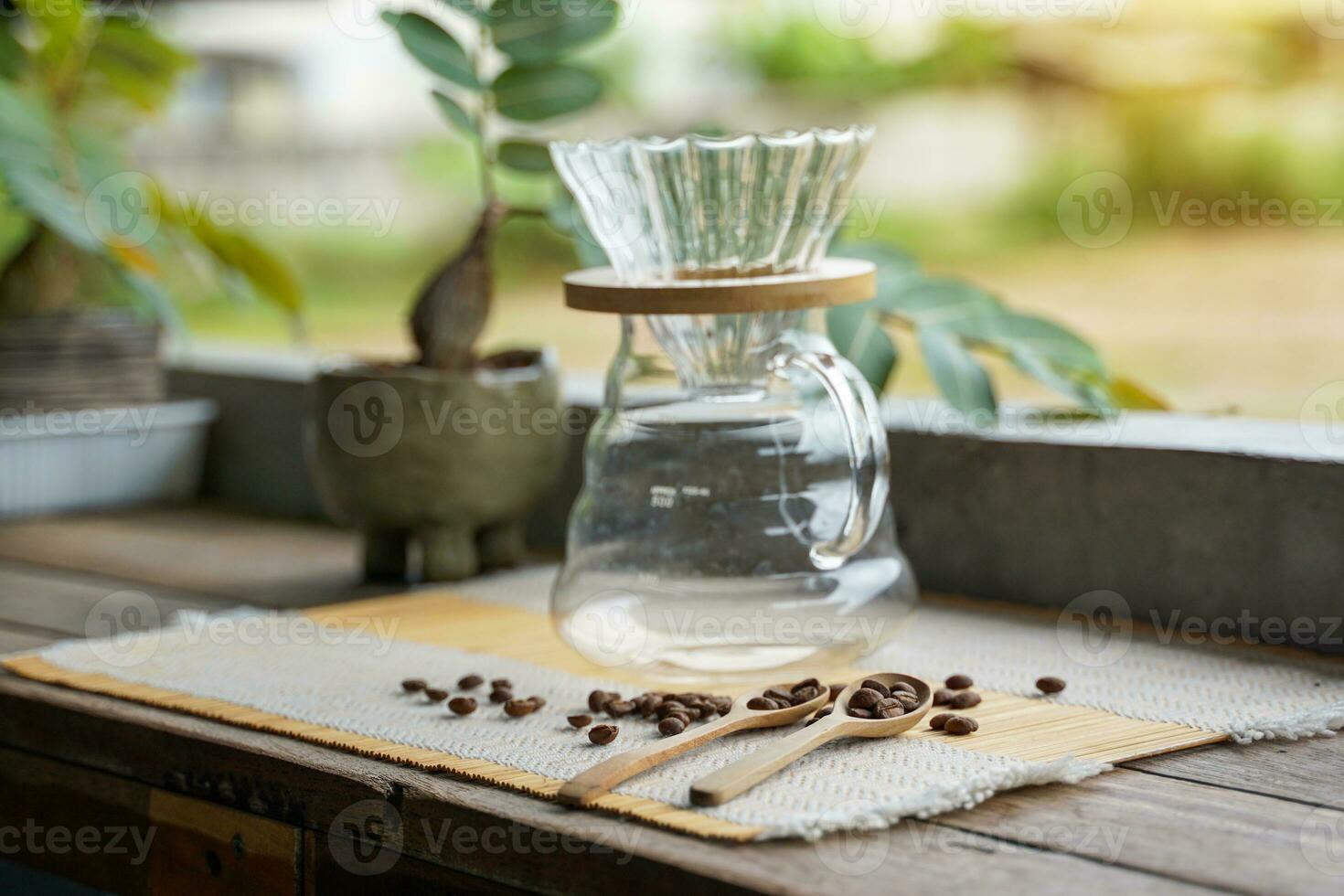 Drip set and coffee beans on a bamboo mat Simple coffee making equipment for people who love black coffee, the aroma and the special taste. specific to that coffee bean photo
