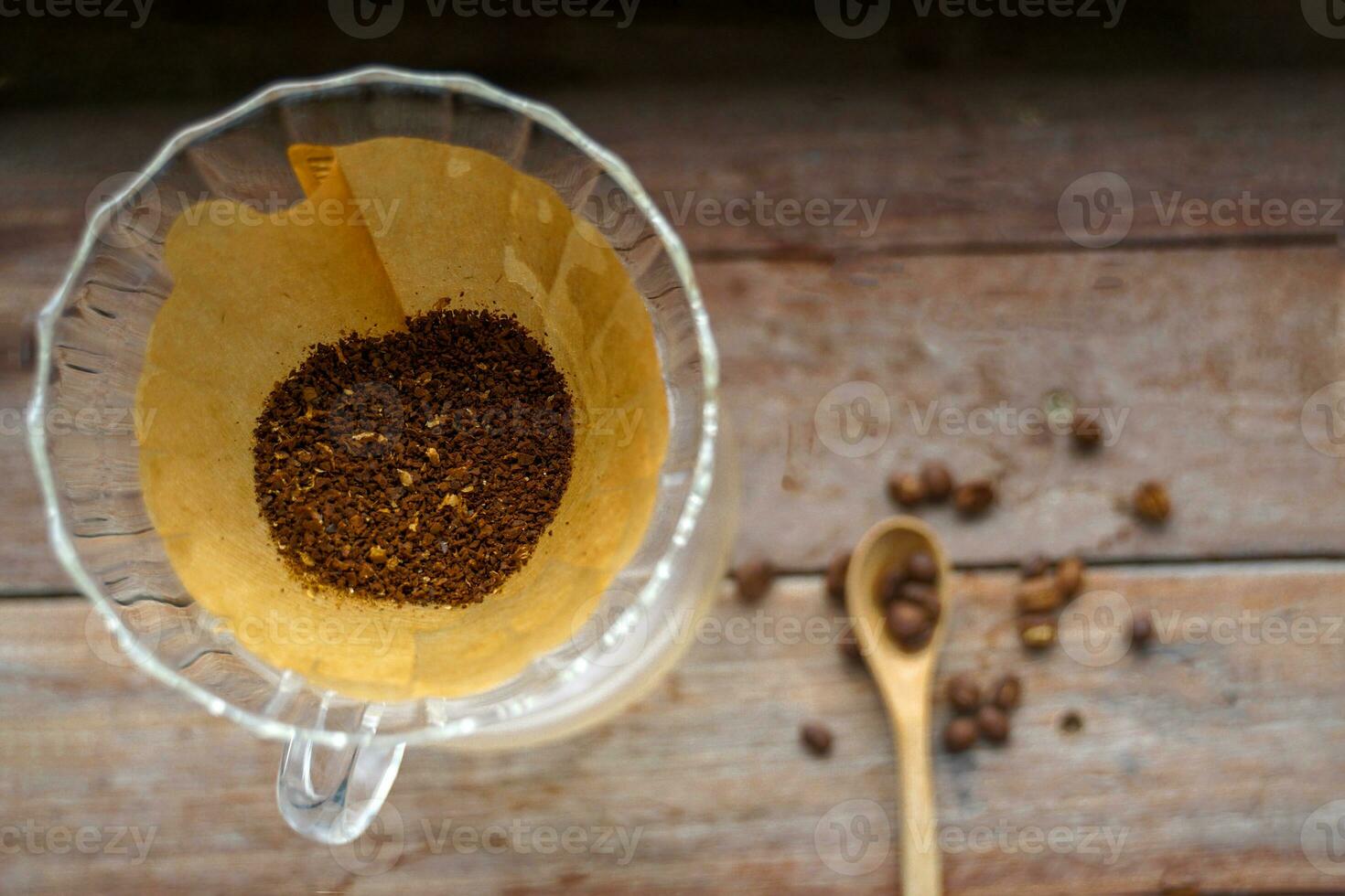 Coffee grounds in a glass dripper This is an easy way to make your own black coffee with just a few tools. And  get a black coffee with a special aroma and taste. only that type of coffee photo