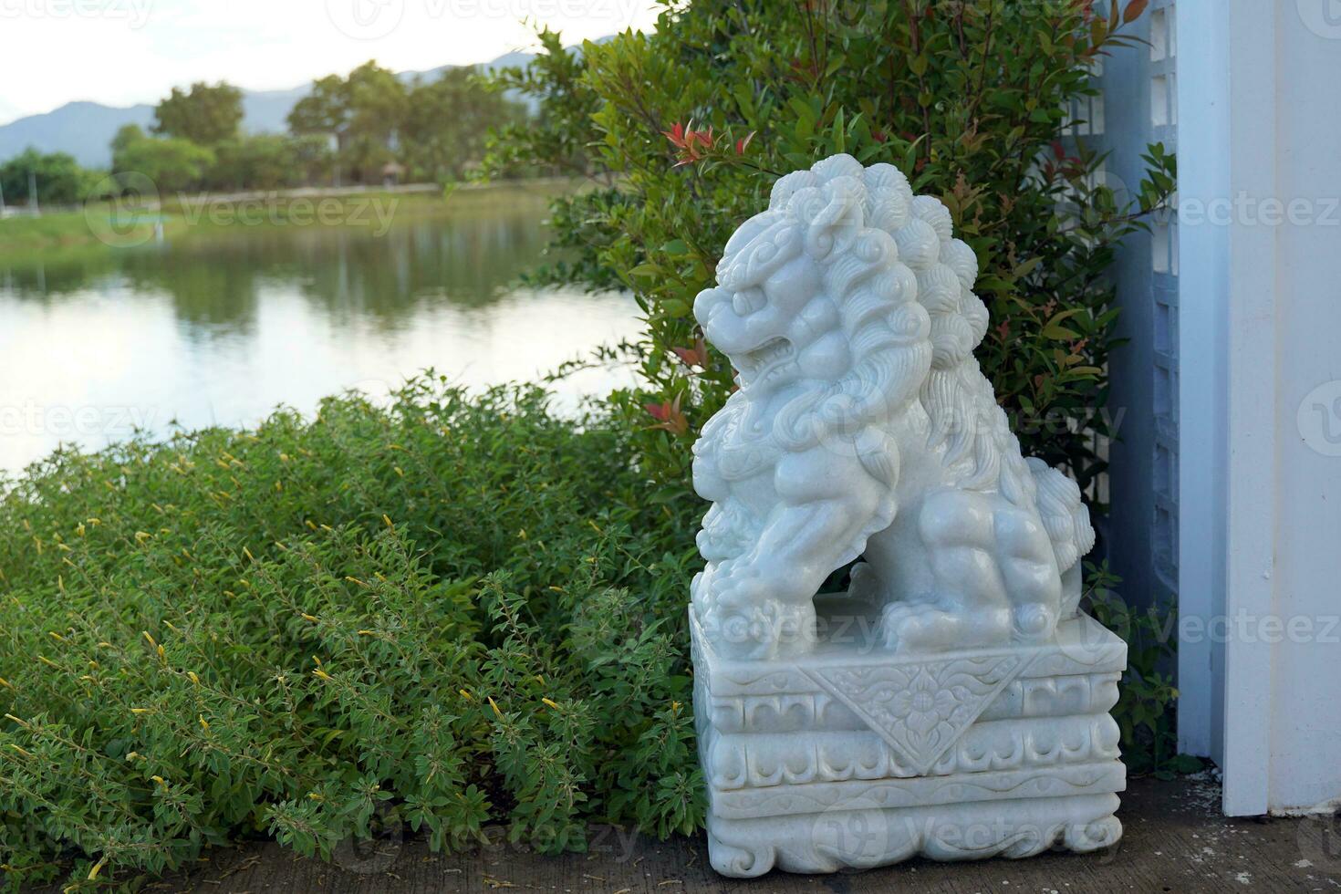 A lion carved from marble is placed in front of the entrance to the resort according to the Chinese belief that it protects from evil. Protection for peace and happiness prosper. photo