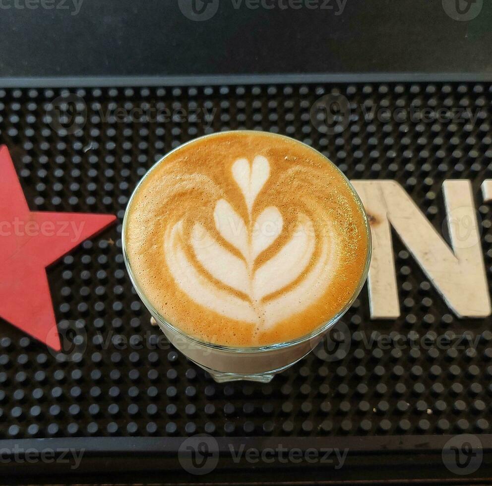 Art latte coffee with tulip art and heart photo