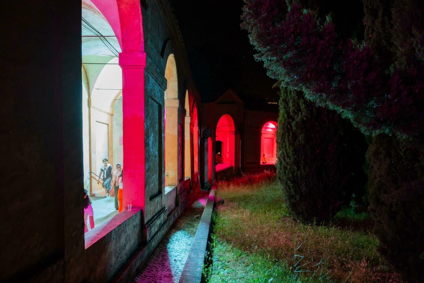 Bologna,Italy- June 23, 2023-People stroll at night under the arcades leading to the sanctuary of San Luca illuminated for the first edition of the Bologna arcades Festival. photo