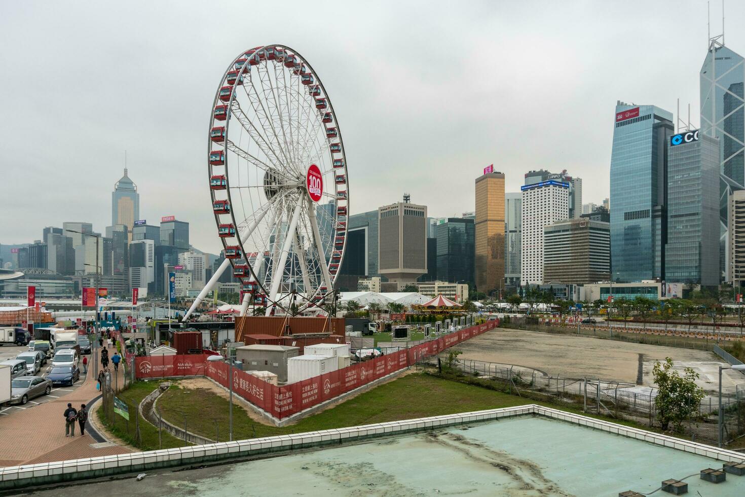 Hong Kong,March 25,2019-The Ferris wheel gi Hong Kong against the backdrop of the city's skyscrapers on a cloudy day photo