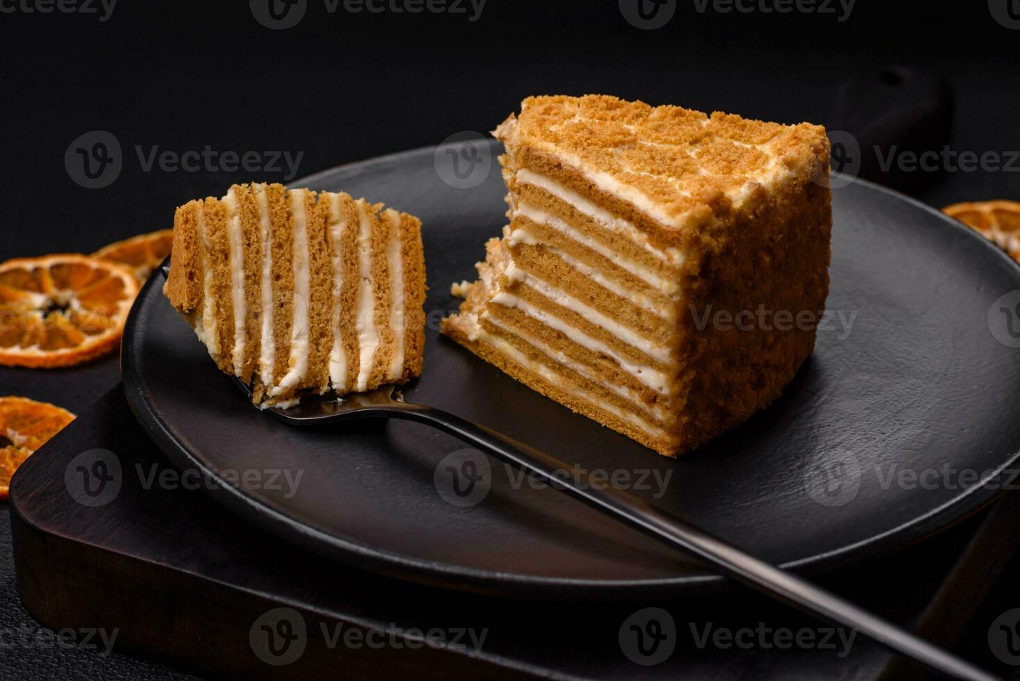 Delicious fresh sweet honey cake layer cake with white cream photo