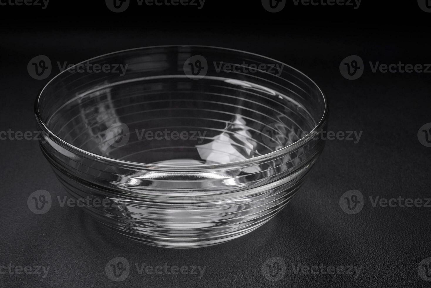 Transparent glass bowl as an element of kitchen utensils for cooking at home photo
