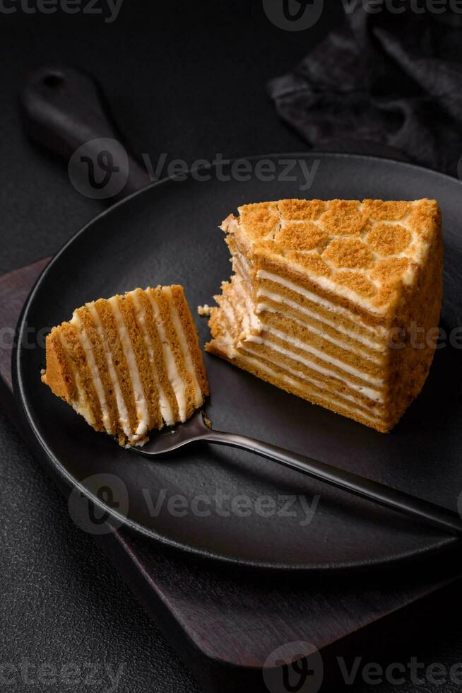 Delicious fresh sweet honey cake layer cake with white cream photo