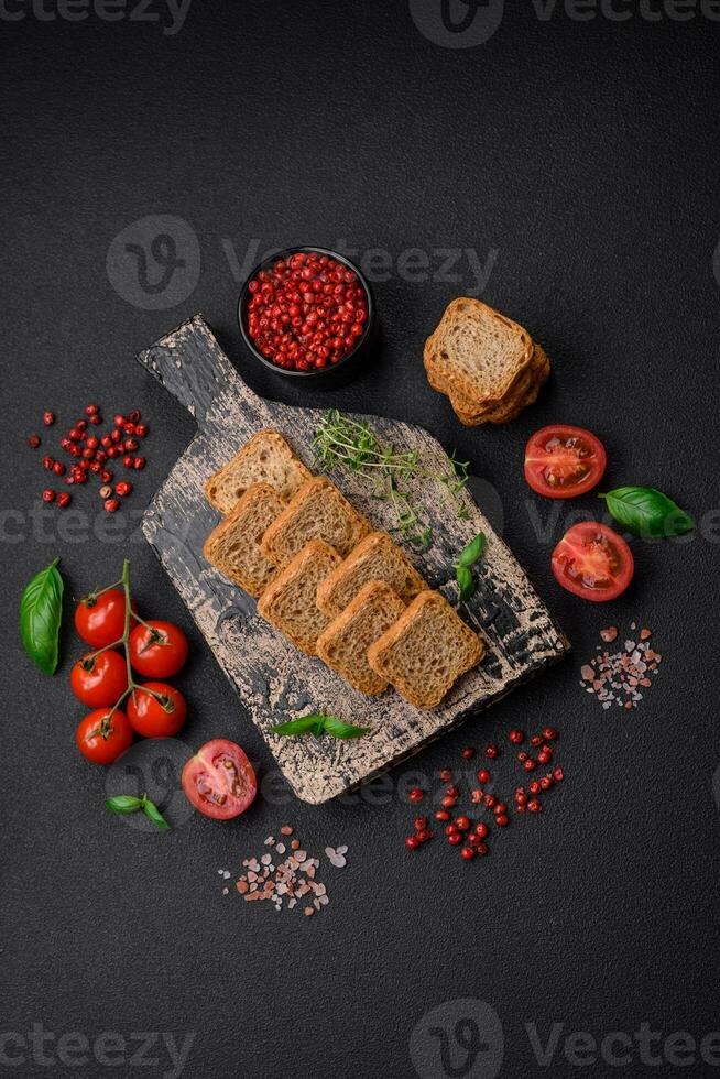 Delicious salted rectangular wheat croutons with salt and spices photo