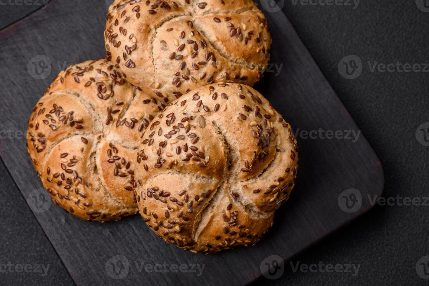 Delicious freshly baked crispy bun or kaiser roll with sesame seeds photo