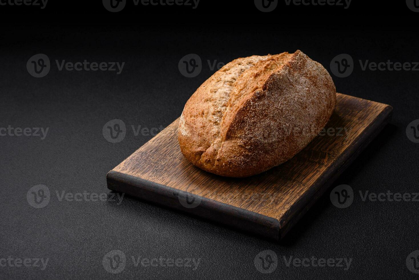 Delicious fresh baked crispy loaf of bread with seeds and grains photo