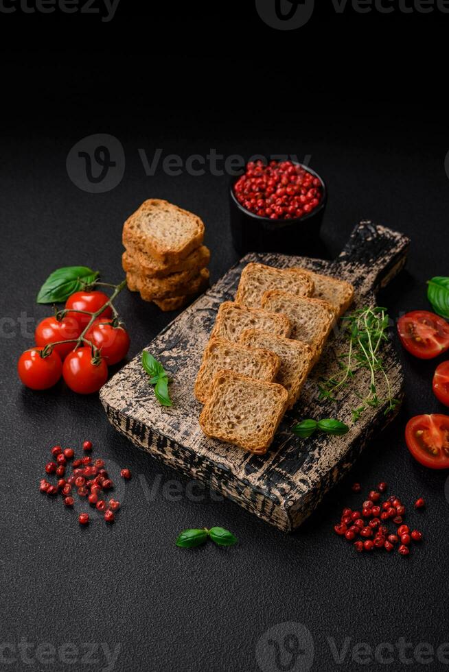 Delicious salted rectangular wheat croutons with salt and spices photo
