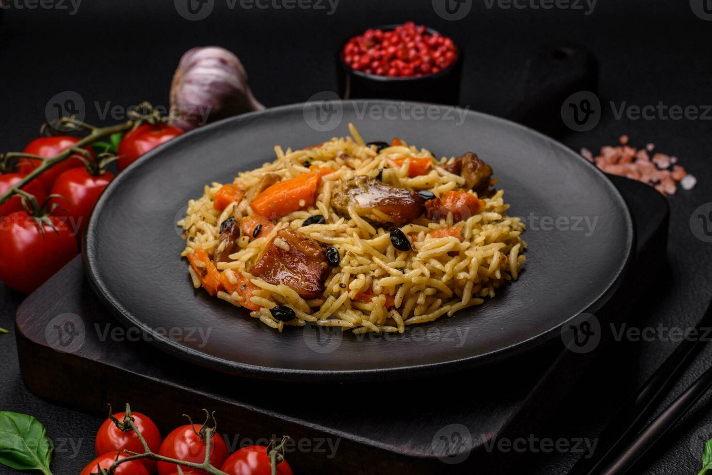 Delicious fresh pilaf with rice, carrots, meat, onions, spices and berries photo