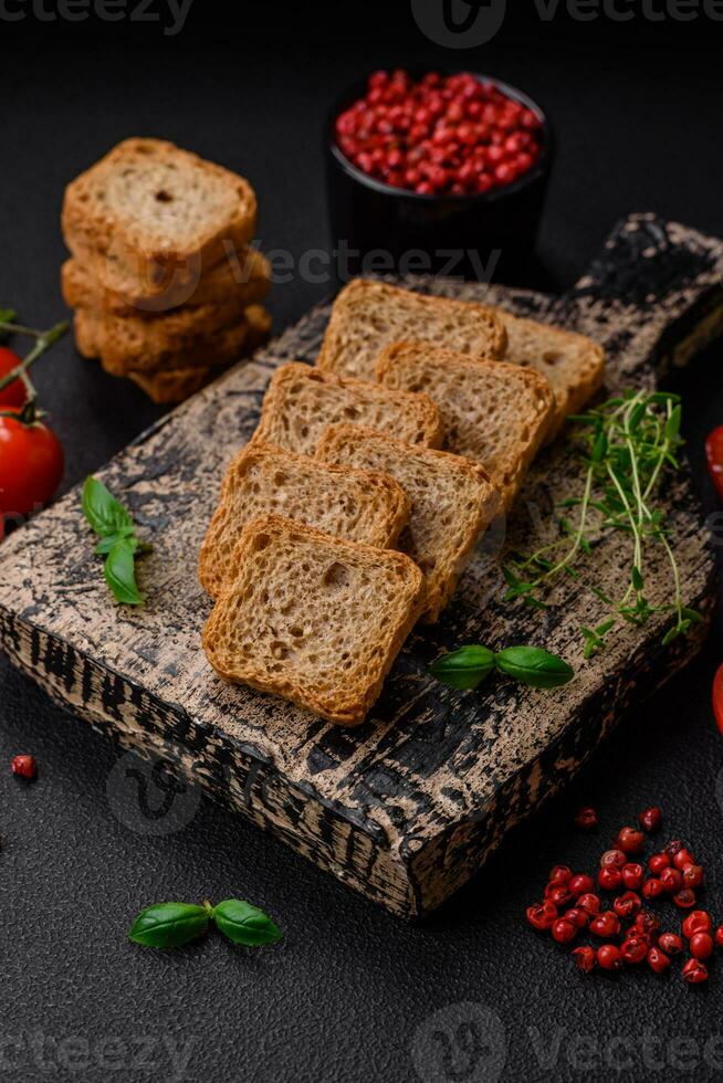 Delicious salted rectangular wheat croutons with salt and spices photo