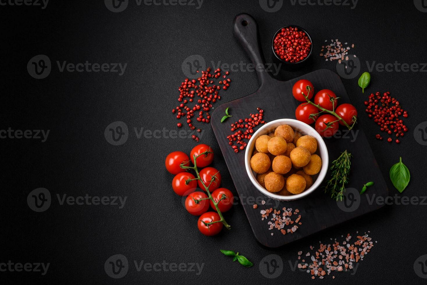 Delicious fried potato balls with breaded mozzarella, salt, spices and herbs photo