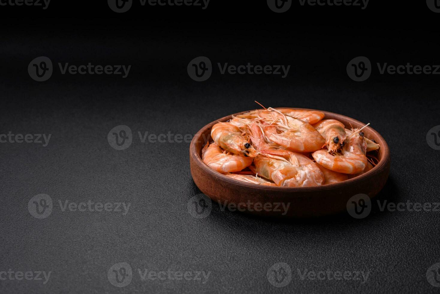 Delicious fresh boiled tiger prawns with salt and spices on a ceramic plate photo