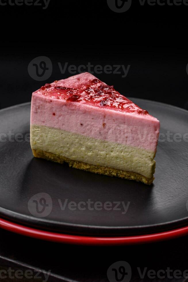 Delicious sweet dessert cheesecake with raspberry and pistachio flavor photo