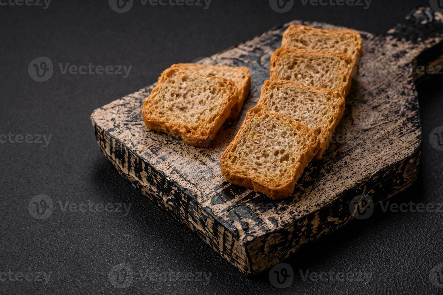 Delicious salted rectangular wheat croutons with salt and spices photo