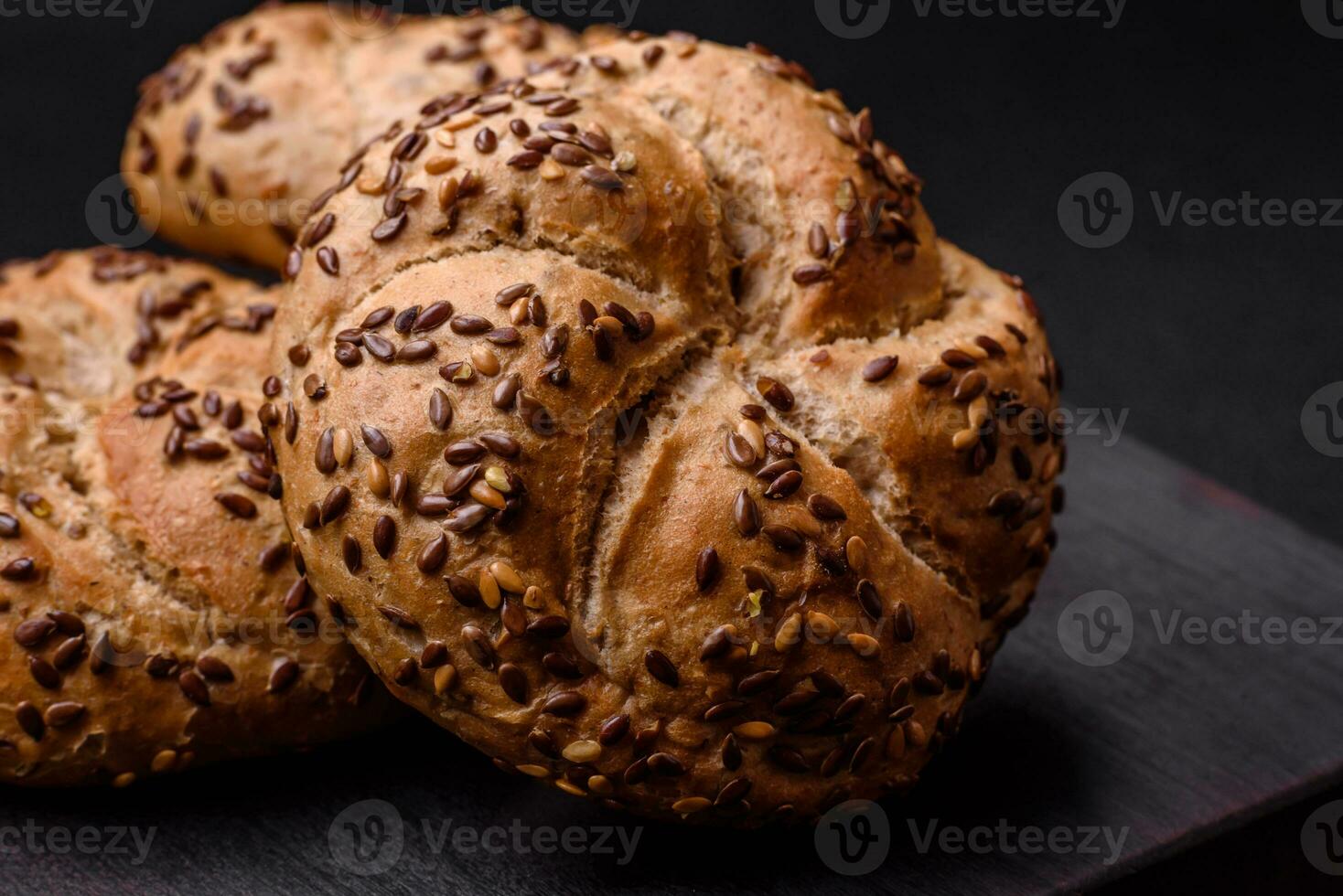 Delicious freshly baked crispy bun or kaiser roll with sesame seeds photo