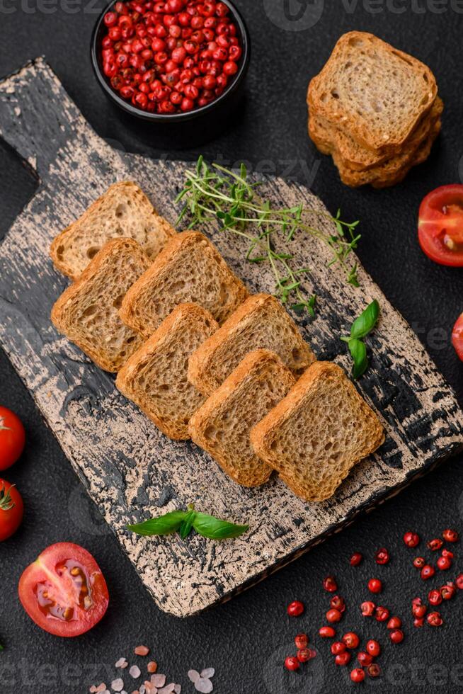 Delicious salted rectangular wheat croutons with salt and spices photo