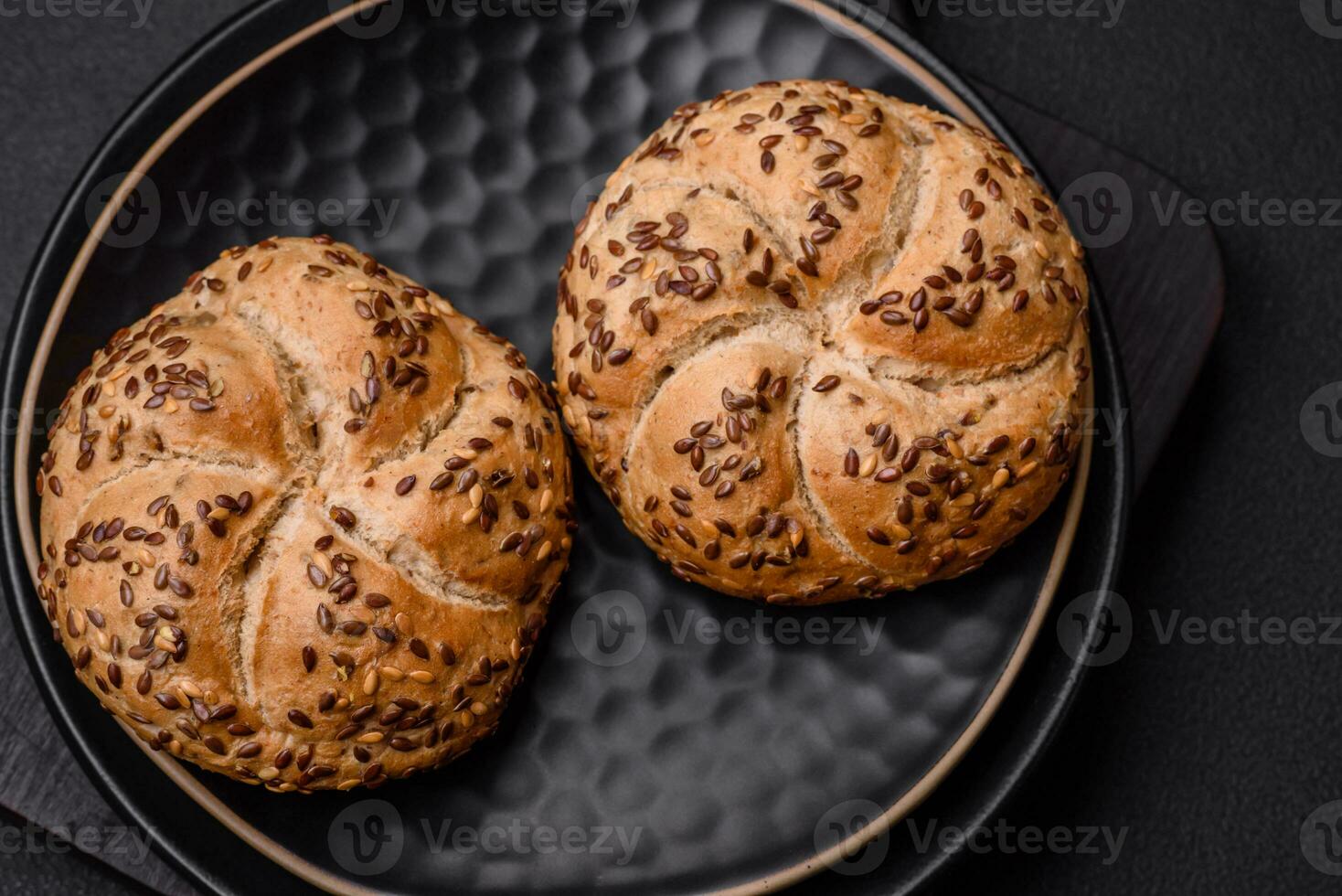 Delicious freshly baked crispy bun or kaiser roll with sesame seeds photo