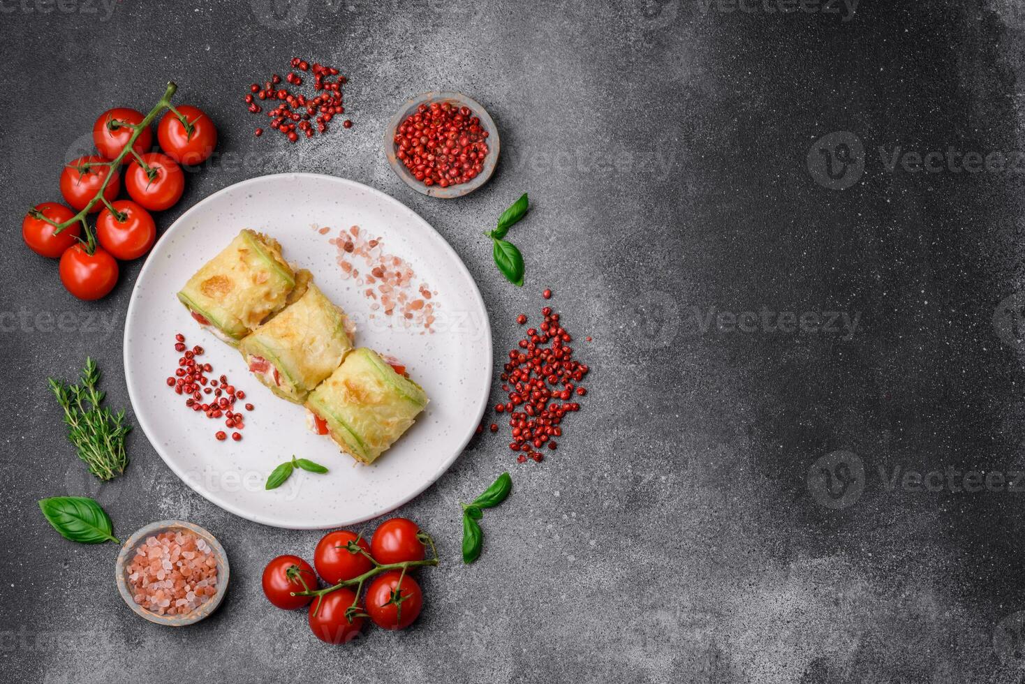 Delicious healthy vegetarian vegetable roll of zucchini, tomatoes, peppers and sauce photo