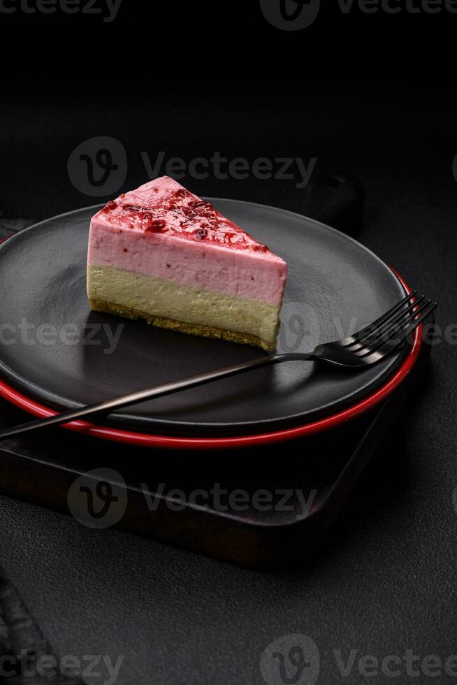 Delicious sweet dessert cheesecake with raspberry and pistachio flavor photo