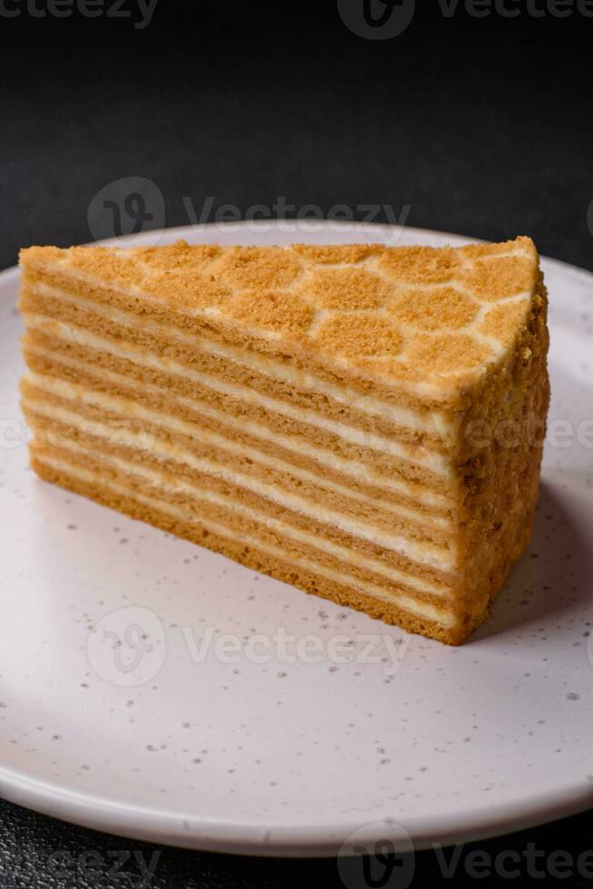 Delicious fresh sweet honey cake layer cake with white cream photo