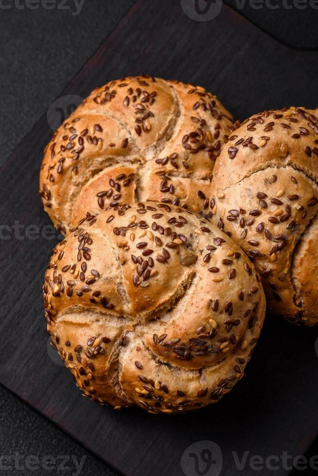 Delicious freshly baked crispy bun or kaiser roll with sesame seeds photo