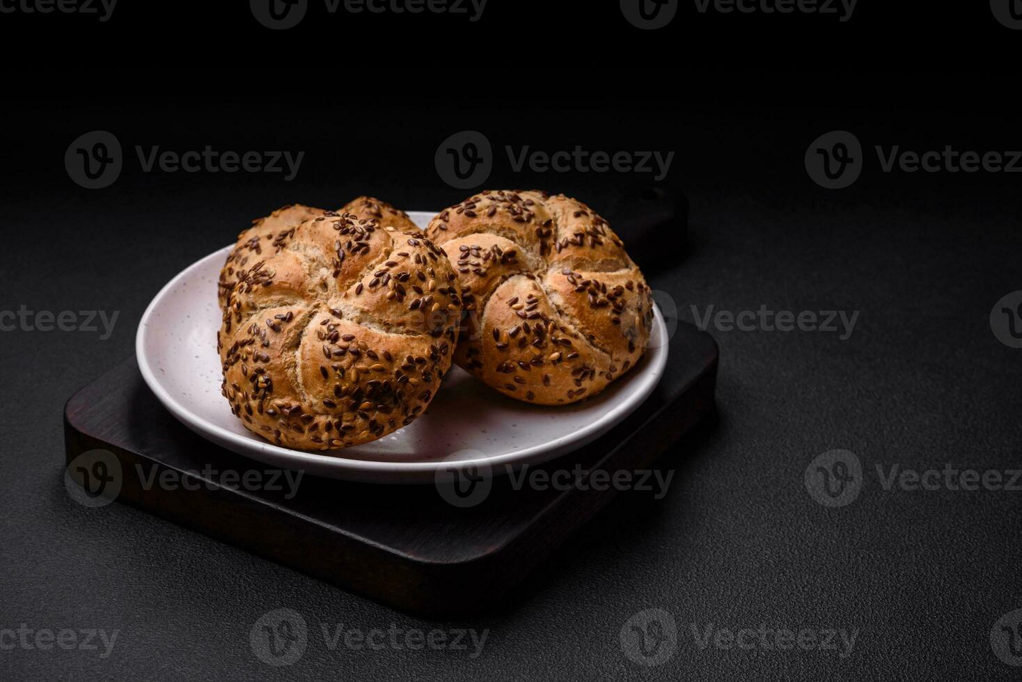 Delicious freshly baked crispy bun or kaiser roll with sesame seeds photo