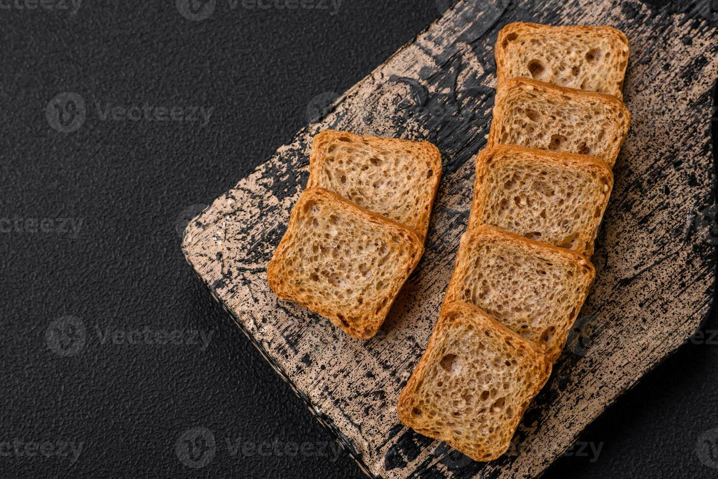 Delicious salted rectangular wheat croutons with salt and spices photo