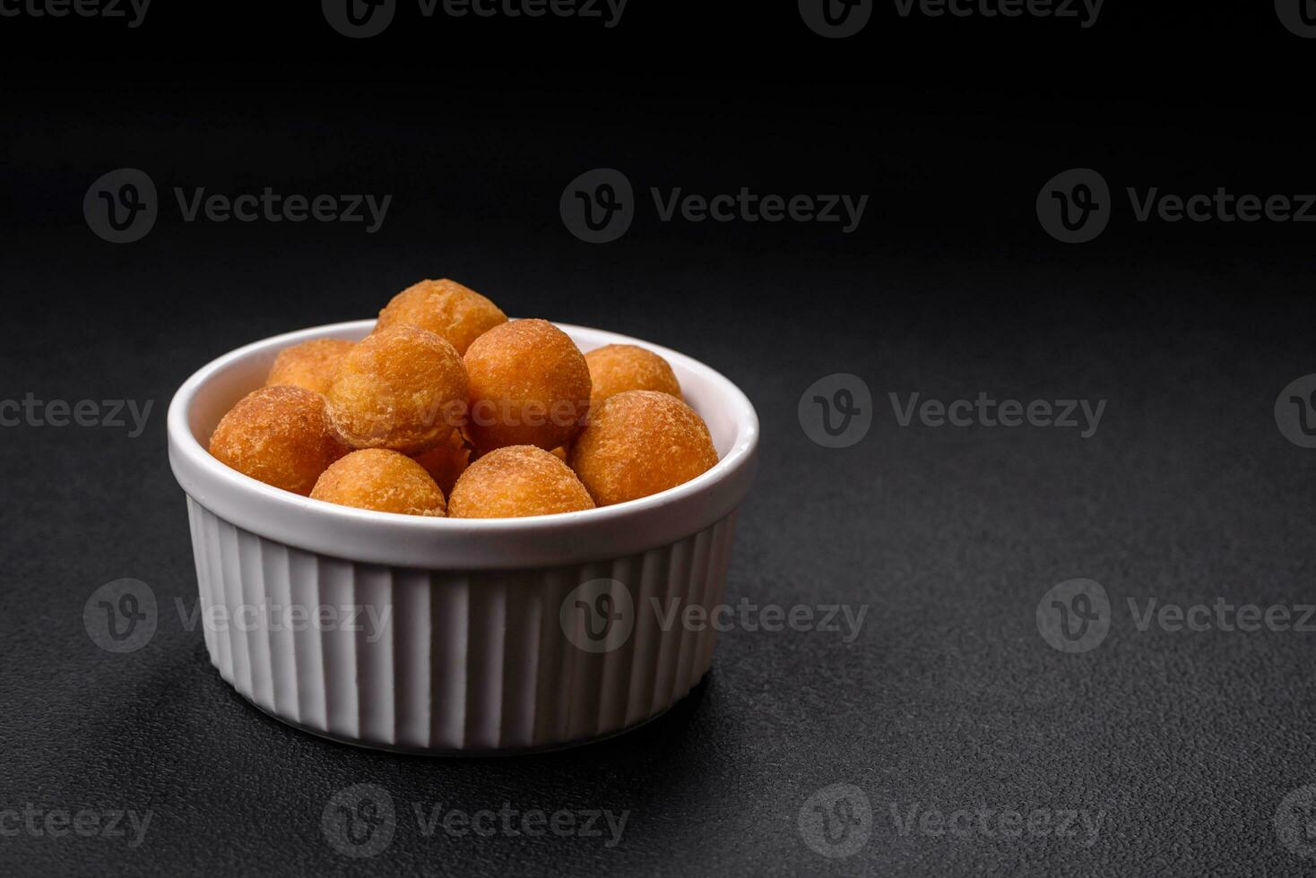 Delicious fried potato balls with breaded mozzarella, salt, spices and herbs photo