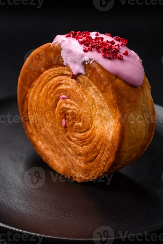 Round puff pastry croissant with raspberry filling or new york roll photo