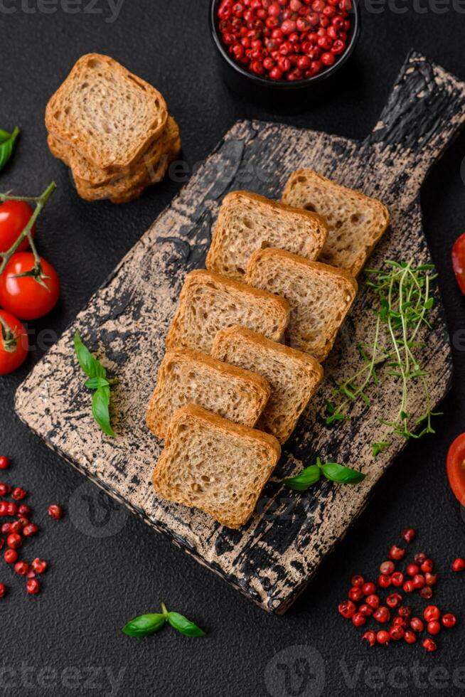 Delicious salted rectangular wheat croutons with salt and spices photo