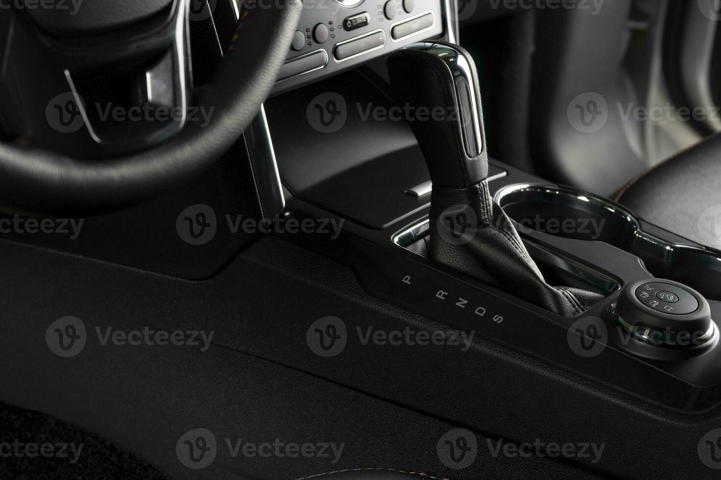 Center console inside a modern and luxurious car - automatic transmission close up photo