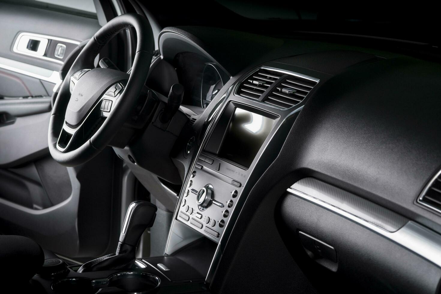View of the interior of a SUV car, modern dashboard with touch screen, black leather seats ideal for the driver photo