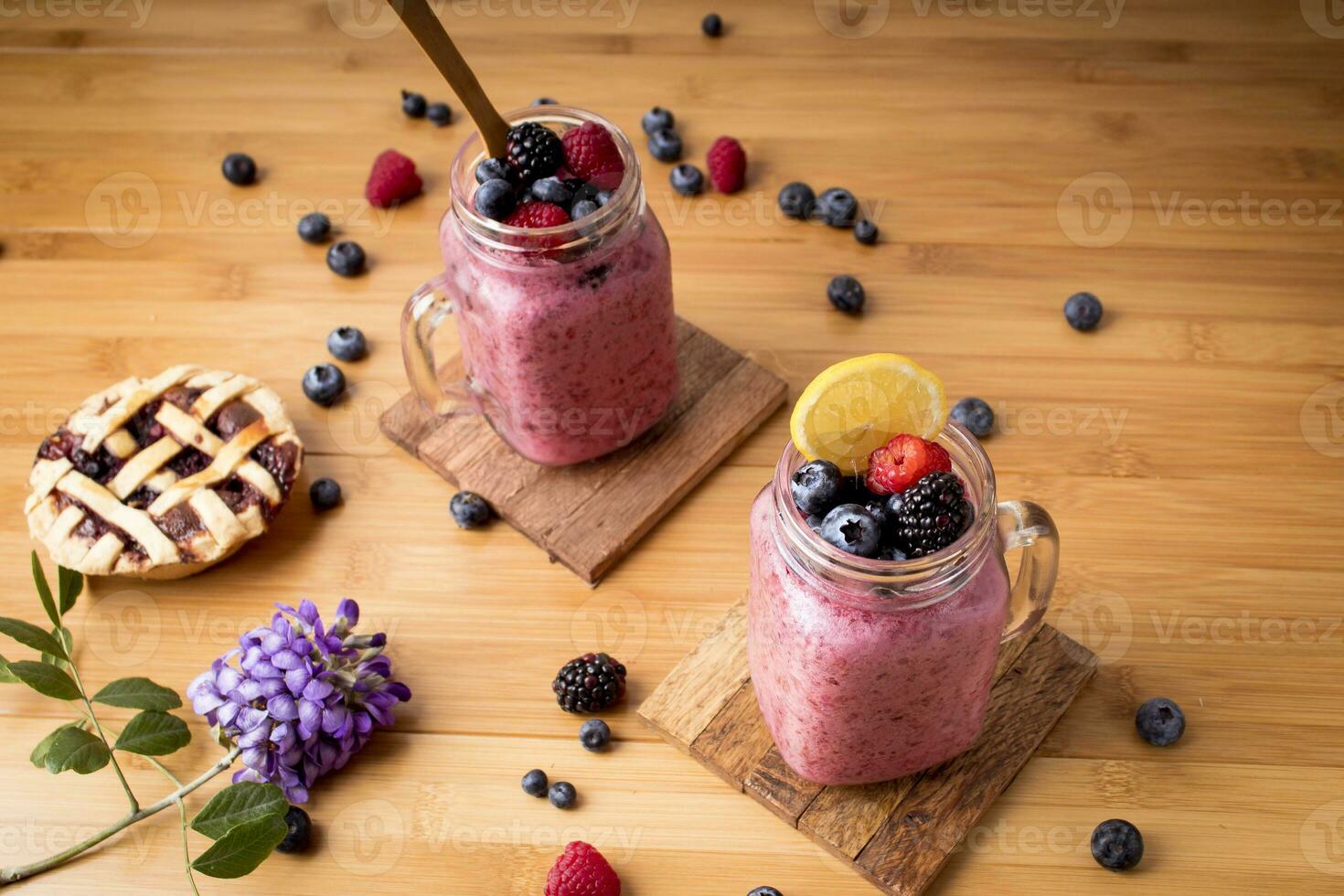 Healthy Breakfast - berry smoothies on bamboo table with natural ingredients photo