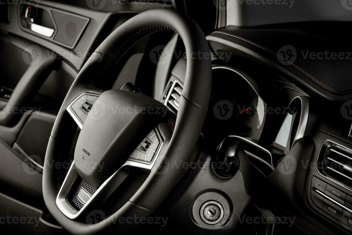 Steering wheel inside a new and modern car for sale, with luxurious details - dark light photo