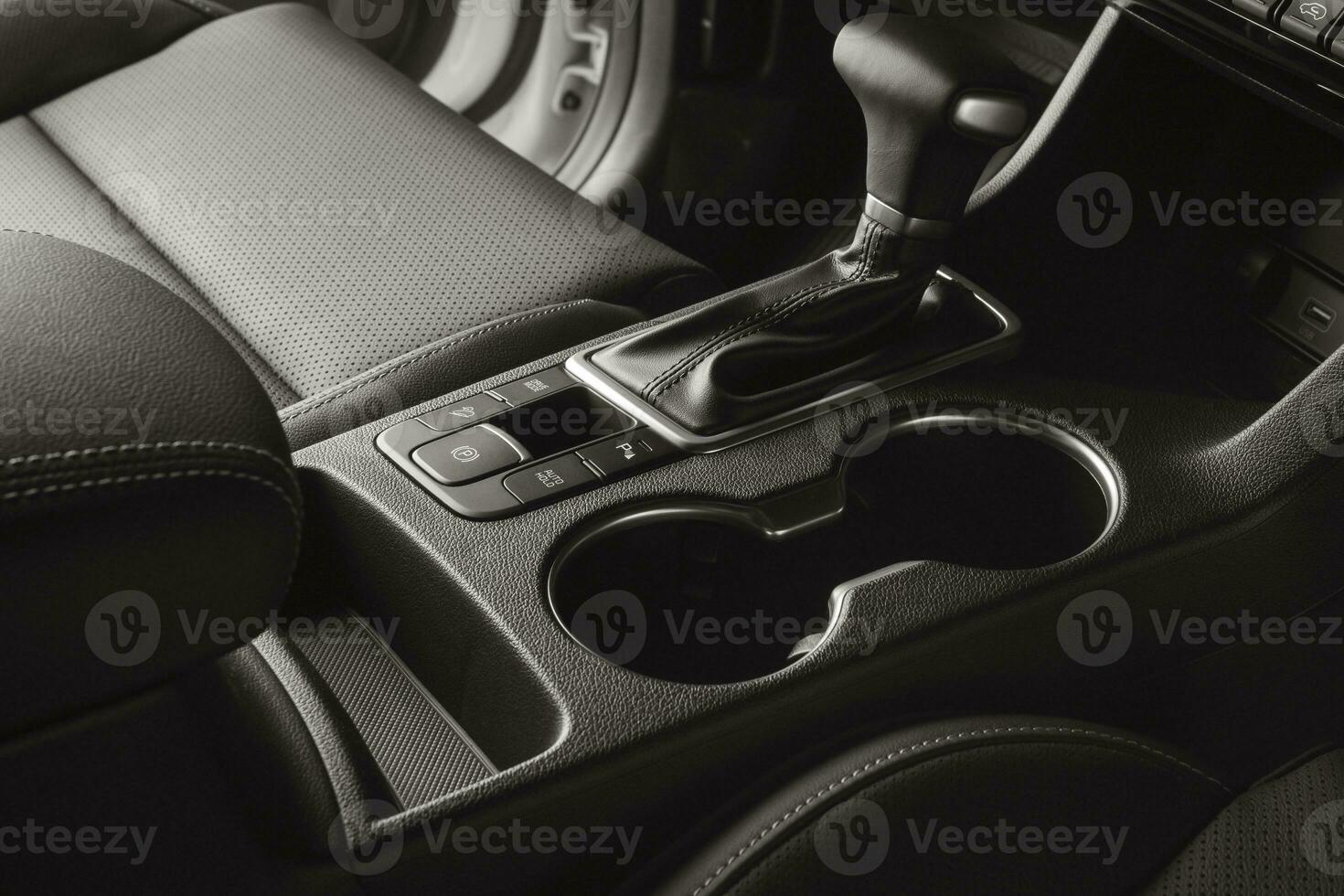 Vehicle interior with black leather seats and automatic gear lever photo