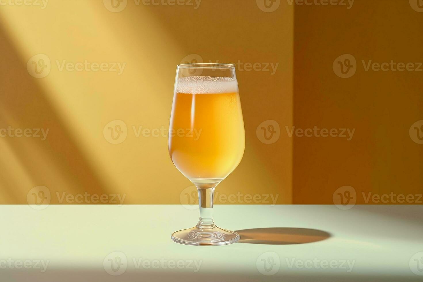 A close up shot of a refreshingly cold glass of golden beer on a table in a sunlit room photo